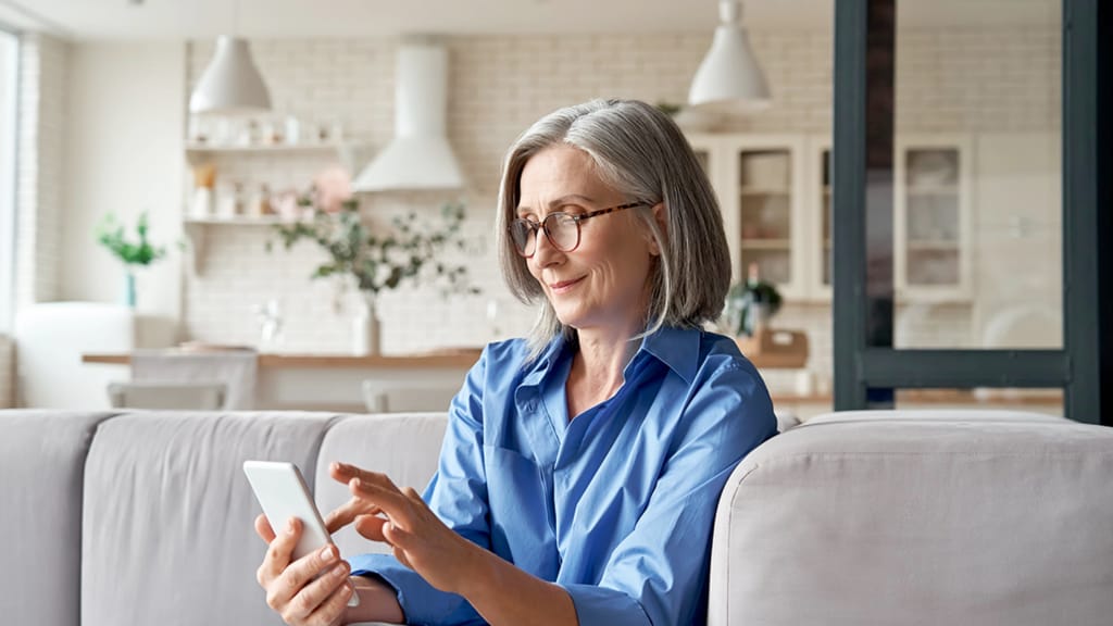 A senior woman using her cell phone.