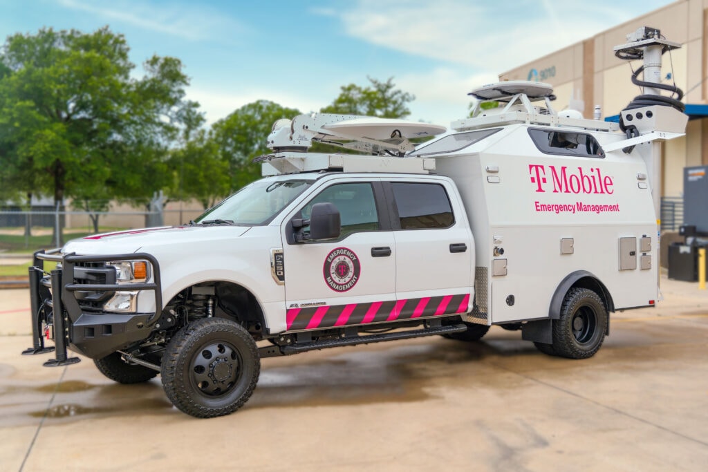 mobile365 logo branded truck titled Emergency Management. Vehicle has satellite equipment retracted to convey portability and is parked outdoors